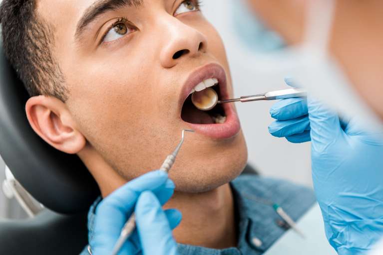 A man getting dental cleaning in Boulder, CO