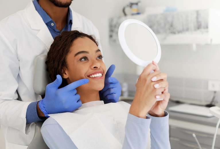A woman smiling after getting Dental Implant in Boulder, CO
